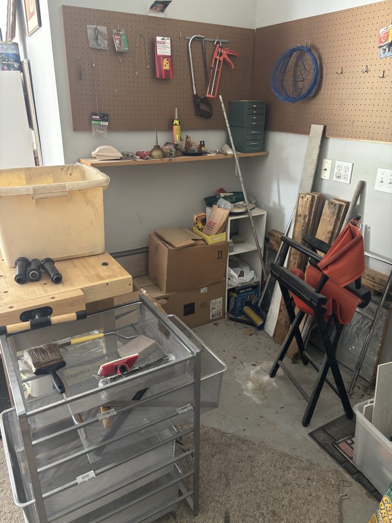 Before photo of a cluttered garage in Omaha, full of boxes, wood, and unwanted miscellaneous junk.