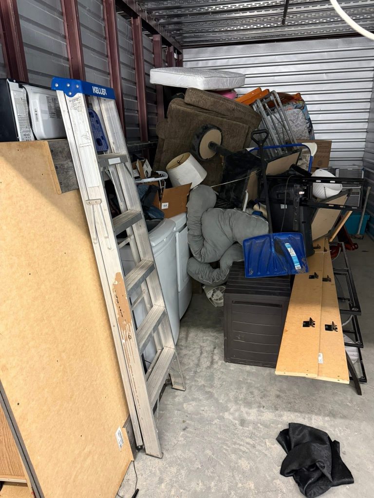 Before photo of a cluttered storage unit in Omaha before junk and furniture removal service.